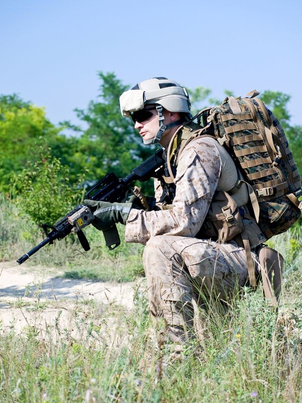 A member of the armed forces in the desert ready to use a personal weapon