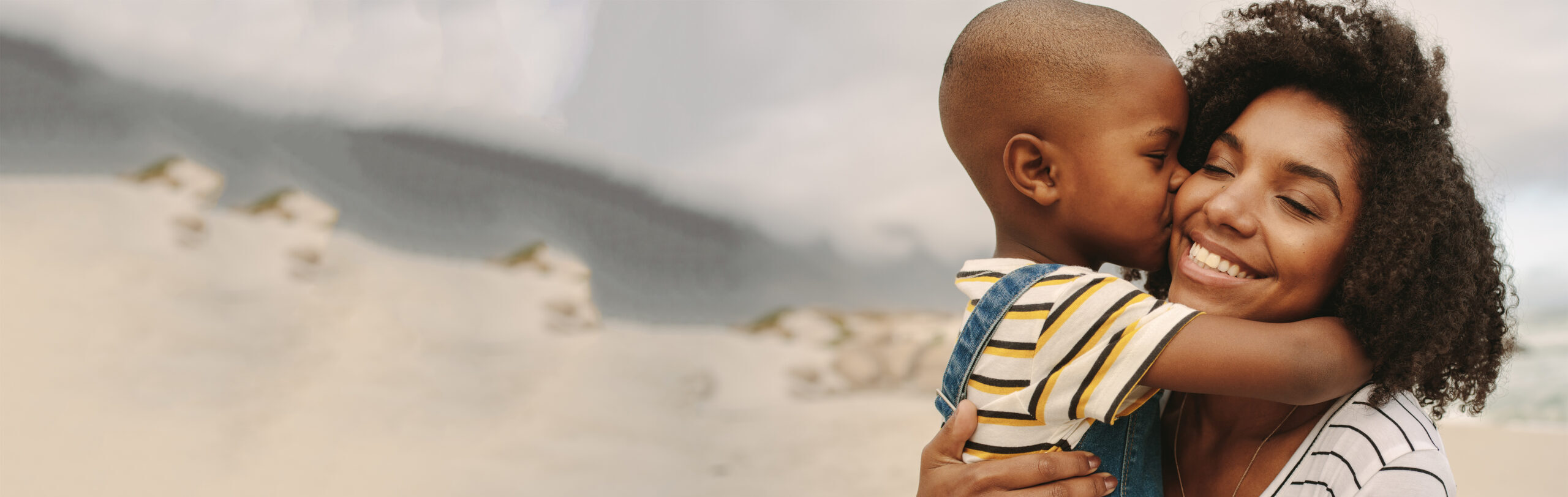 Boy enjoying at day out with his mother on the beach