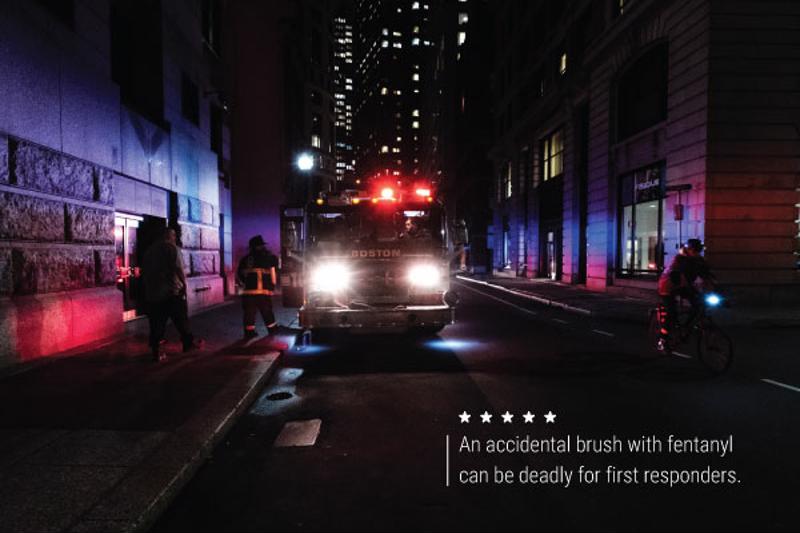 A night shot of a firetruck and firefighters. Text reads, "An accidental brush with fentanyl can be deadly for first responders."