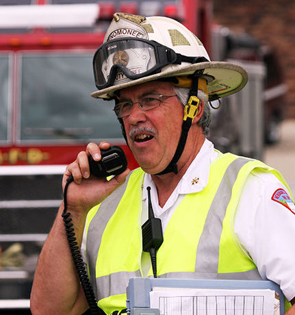 A firefighter talking on the radio emergency scene