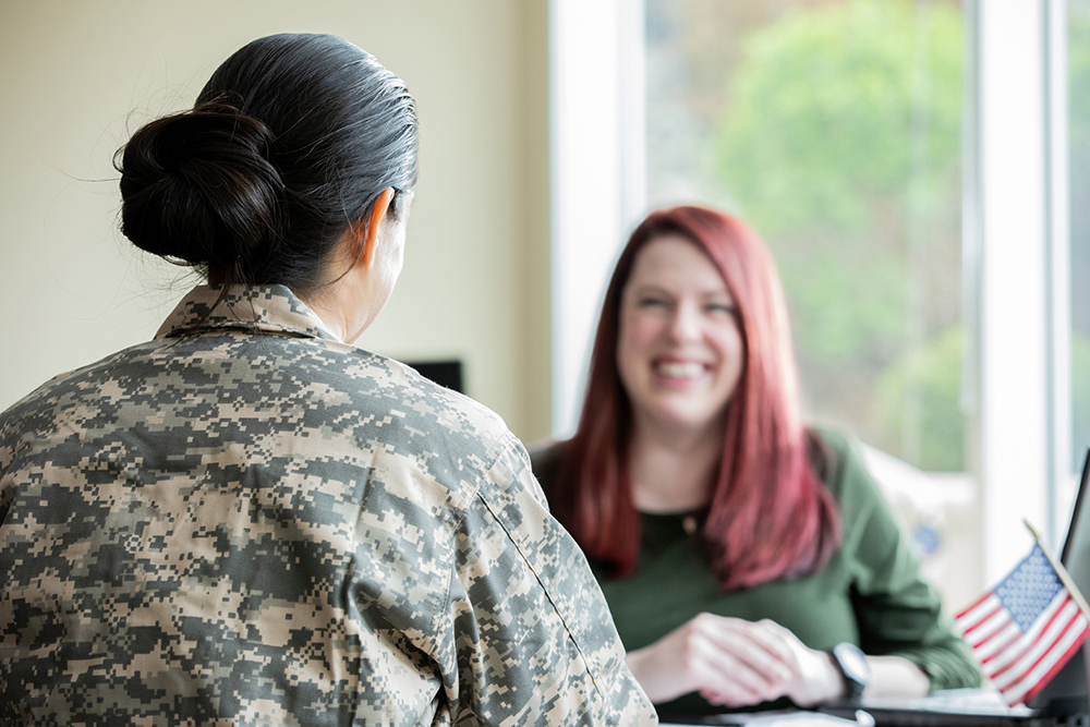 Mature female financial planner speaking to military female.
