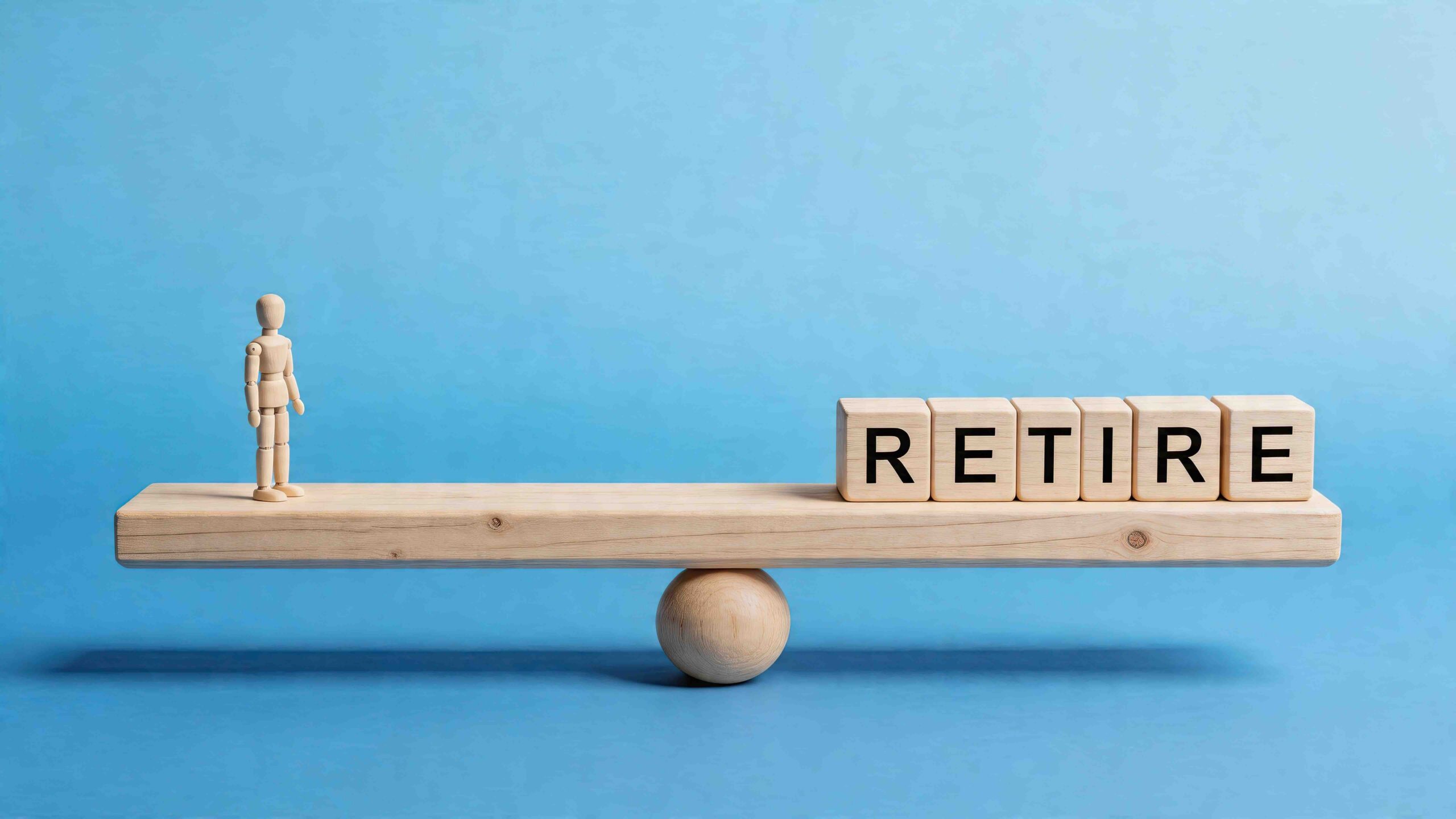 Image of a wooden figure with the word retire on a balance scale